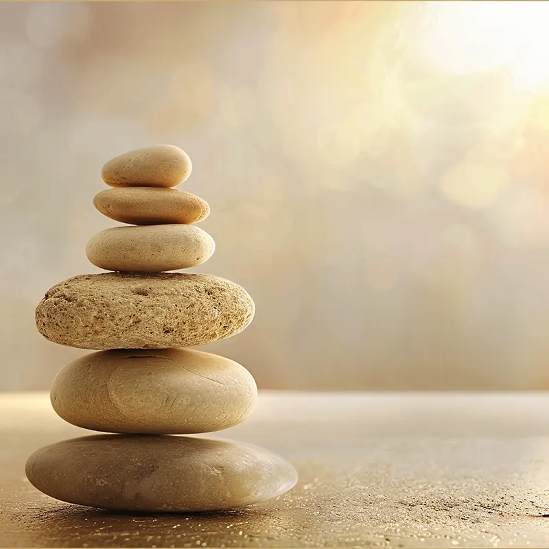 Zbalansowane kamienie symbolizujące harmonię ciała i duszy osiąganą dzięki praktyce Soul Body Fusion